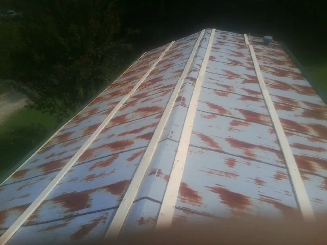Rusted metal roof panels with new wood purlins before replacement — Storm Damage Roof Repair in Dinwiddie by Roofing Brothers